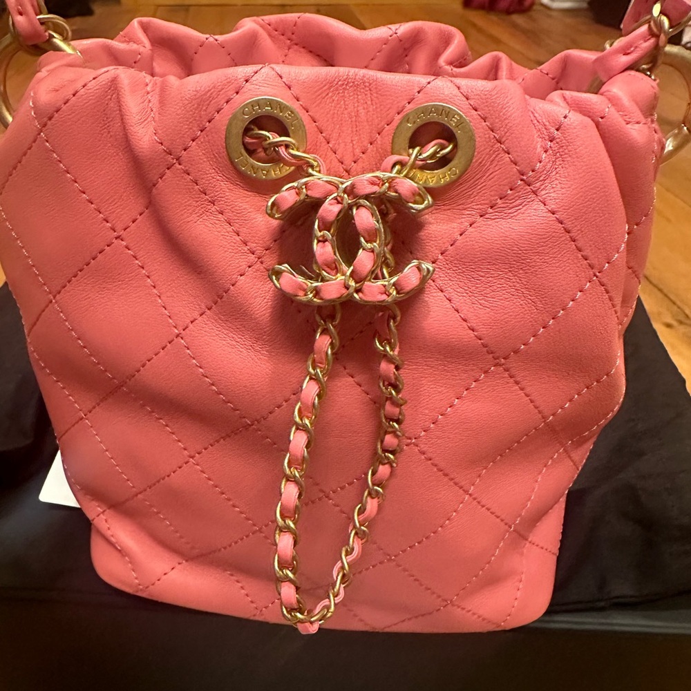 Chanel pink quilted lambskin drawstring bucket bag w/ gold hardware.